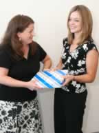 two woman with paper